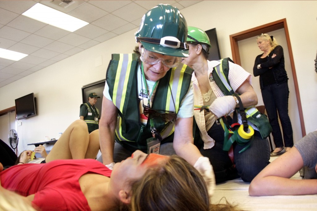 CERT volunteers assess “victims,” played by members of the National Charity League, in the triage station. 