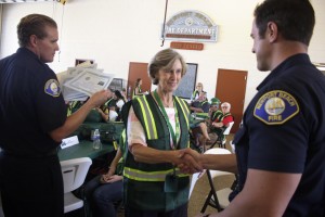 A new CERT graduate receives her diploma on Saturday.