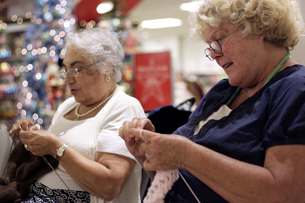 Astrid Sciolini of Costa Mesa (left) and Judy Treble of Tustin knit and crochet items in Macy’s at Fashion Island on Saturday for Spa Gregorie’s sixth annual Knit One, Cure Too knit-a-thon event for the Orange County affiliate of Susan G. Komen for the Cure. — All photos by Sara Hall