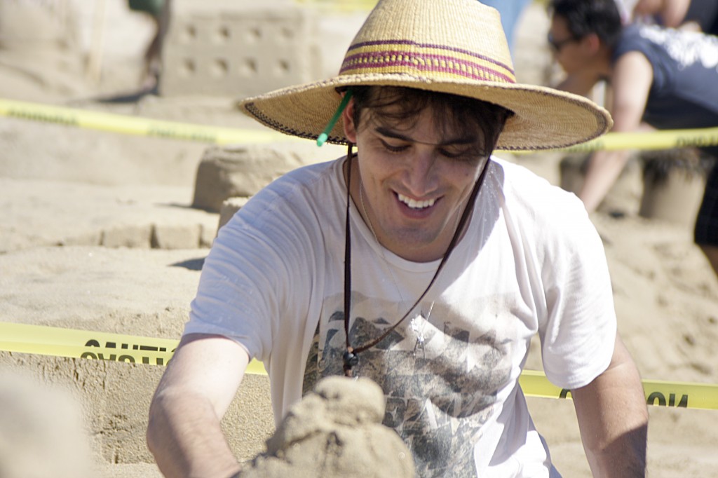 Rion Suarez of Los Angeles works on the McCool Family sand sculpture on Sunday.