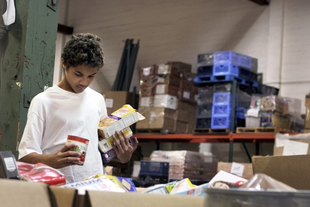 Ea Olotoa scans the bins while sorting donated items at the Second Harvest warehouse on Saturday.