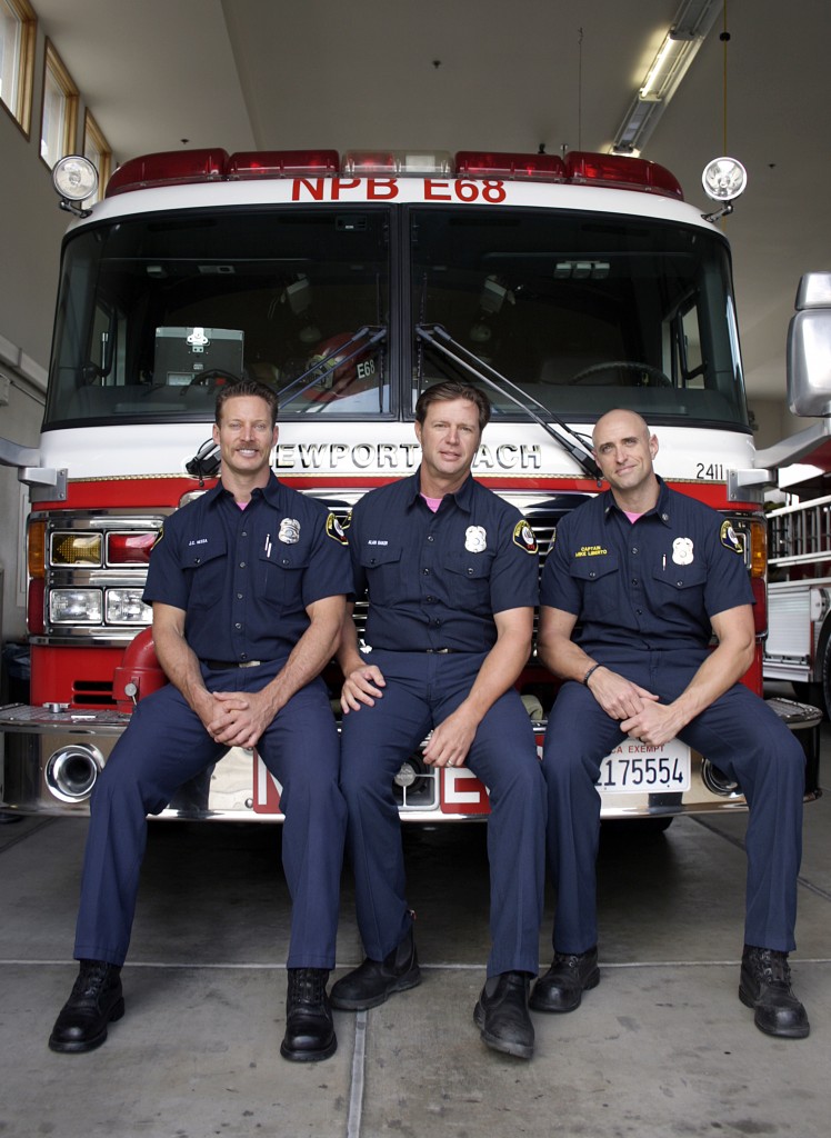 (left to right) NBFD paramedic J.C. Nessa, engineer Alan Baker and fire investigator Capt. Mike Liberto from NBFD station eight, along with the rest of the department, will wear their pink Breast Cancer Awareness shirts underneath their uniforms during the month of October. 