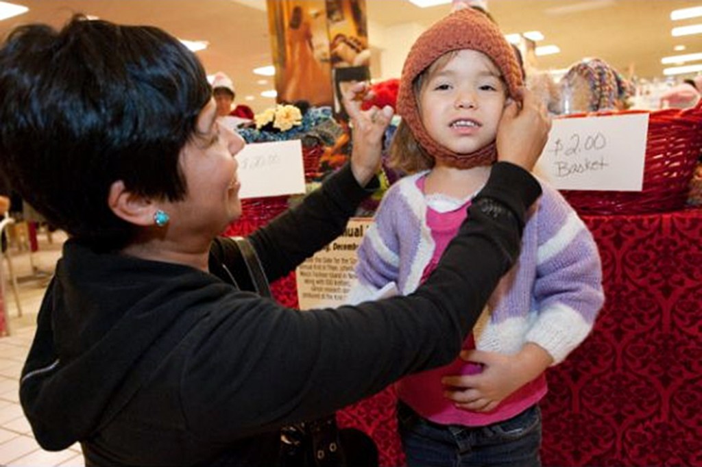 A shopper purchases a cap at the 2011 Knit-a-Thon event. — Photo by Kathy Leek 