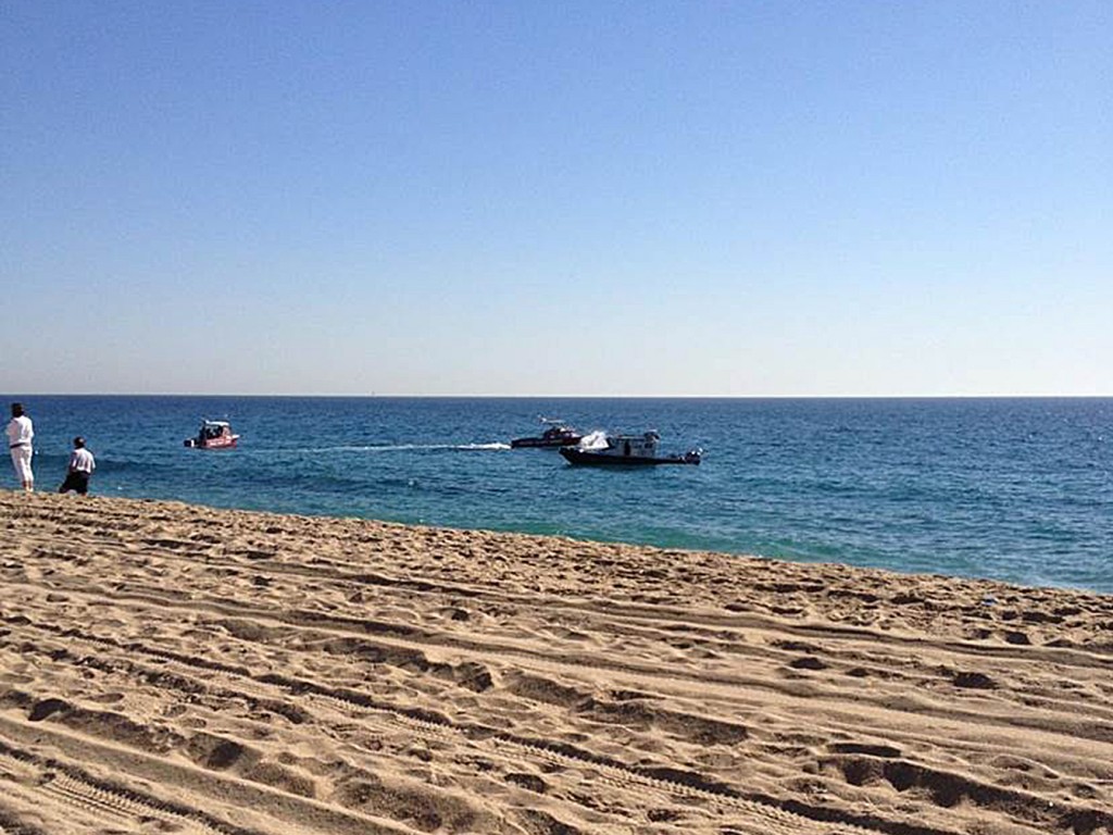 Authorities rescue a man who jumped from a helicopter into the water near Balboa Pier on Tuesday.  Photo by Michelle Rousset