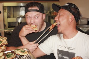 Chef Trevor Kotchek and Sgt. Pepperoni's co-owner Andy Hong clown around in the kitchen