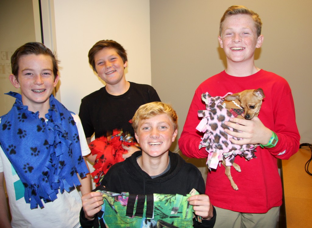 Campbell Norris, John Olmstead, Ethan Barnes and Sam Barela, all 13, holding Sunny, who was adopted at the event. — Photo by Allison Olmstead/Townsend Olmstead Media Company