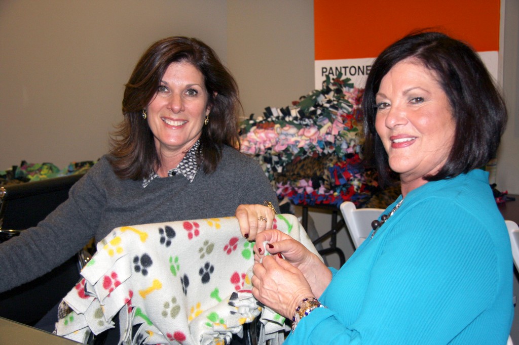 Sisters Laura Gale, HÔM agent, and Amy Brown, The Make It Count Project founder chat as they work on a dog blanket. — Photo by Allison Olmstead/Townsend Olmstead Media Company