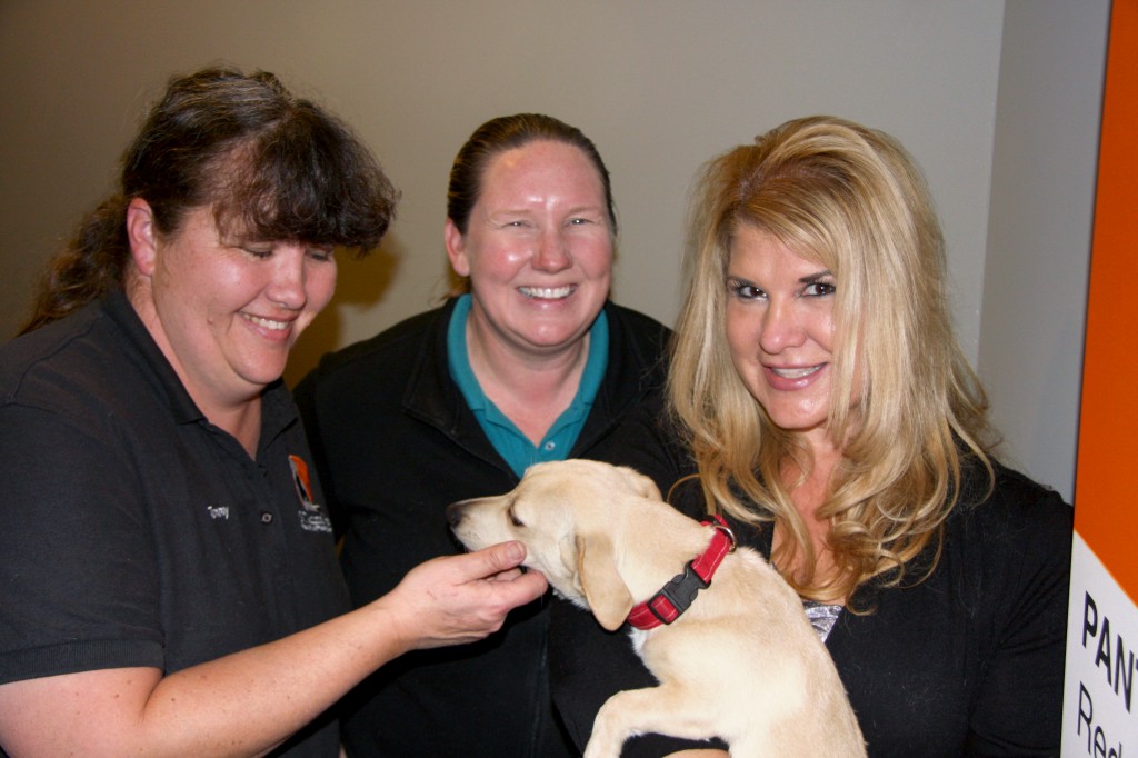 Tammy Osborn, Katie Ingram, Community Outreach Supervisor at OC Animal Care, and Karen Weinberg, with Barney. — Photo by Allison Olmstead/Townsend Olmstead Media Company