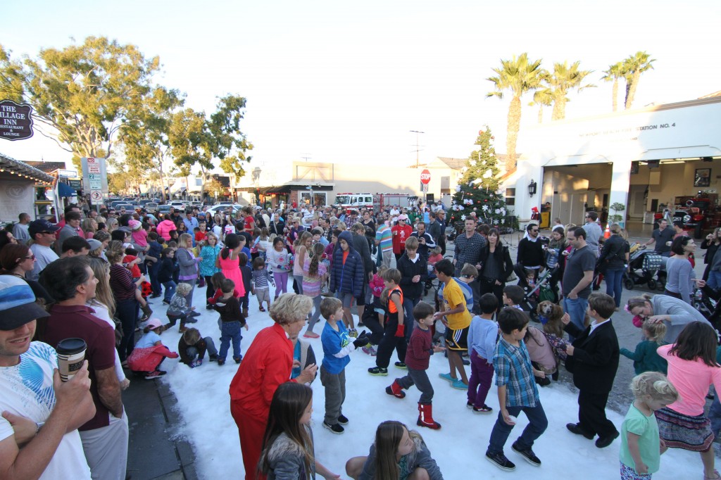 Local children enjoy real snow that was brought to Balboa Island last weekend. — Photo by Jim Collins