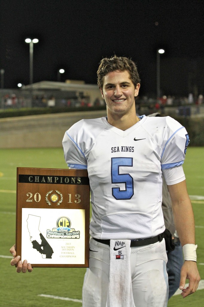 CdM quarterback Luke Napolitano with the team's winning plaque.