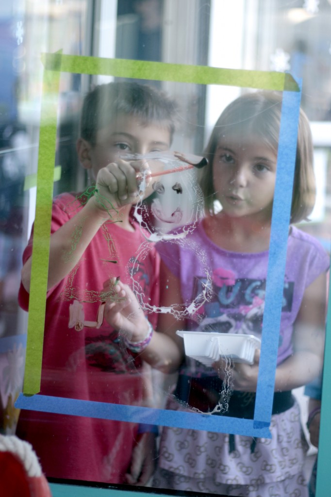 Brother and sister Lincoln, 5, and Ollia, 8, Fontana work on a painting together.