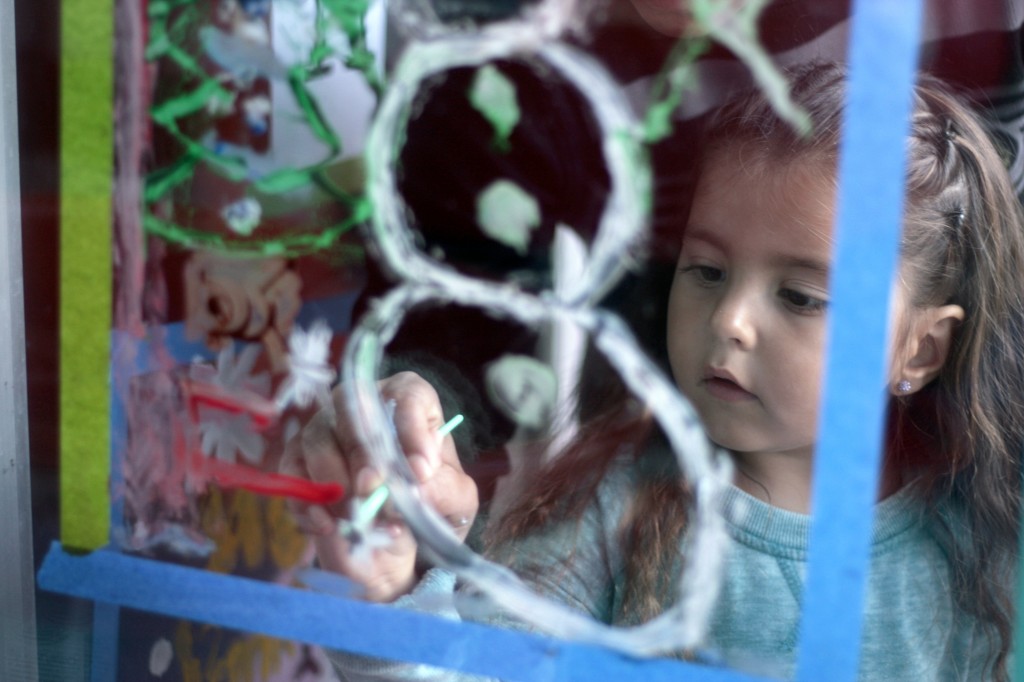 Lucia Fontana, 4, a pre-kindergarten student, adds the finishing touches to a snowman scene she worked on with her brothers Lincoln, 5, and Lenz, 6, and sister Ollia, 8.