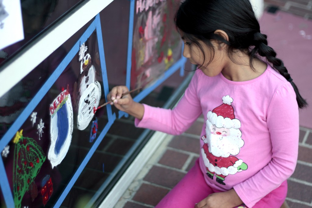 Desaiya Florian, 7, a second grader, works on her painted display at ExplorOcean on Wednesday.