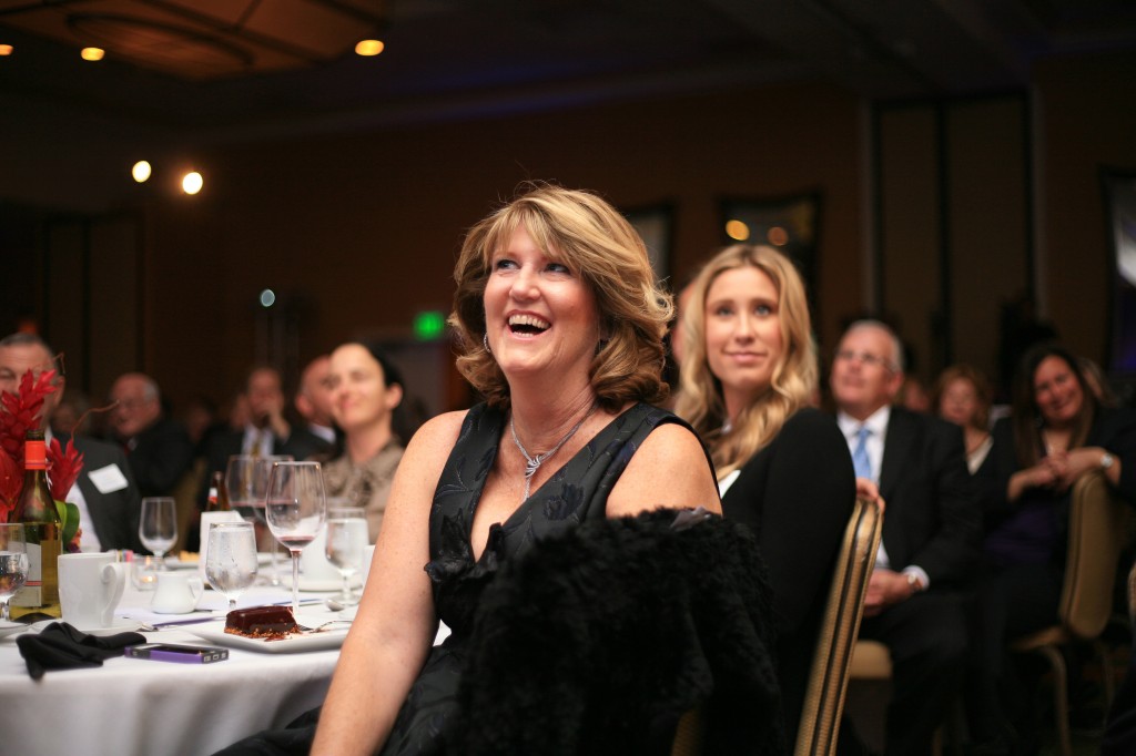 Mayor Rush Hill's wife, Linda, laughs at a joke Hill makes during his "State of the City" speech.