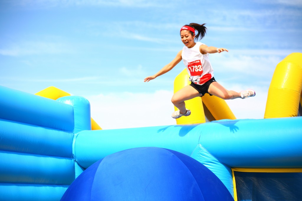 A Hit and Run participant jumps into the second obstacle along the course, the Bouncy Bridge.