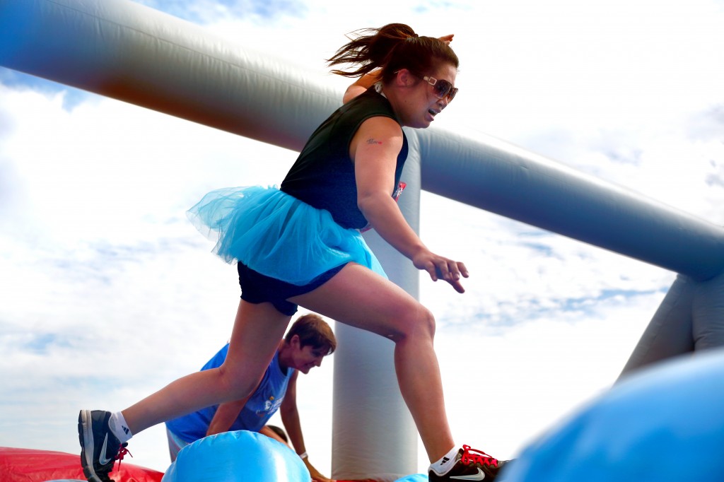 A Hit and Run participant tries to run over the inflatable posts in the Wobble Walk obstacle.