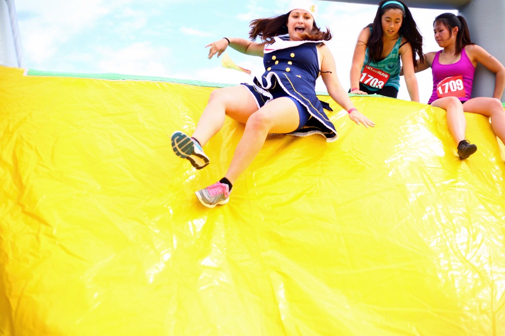 Jackie Dixon slides down the last part of the Wobble Walk obstacle.