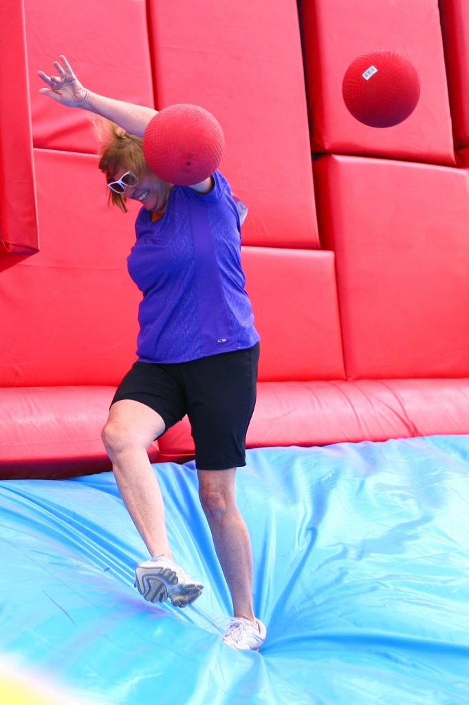 A woman gets knocked in the get with a red ball thrown by another Hit and Run participant at the Whacking Wall obstacle.