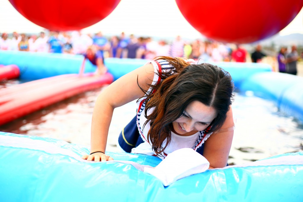 Jackie Dixon crawls out of the last obstacle.