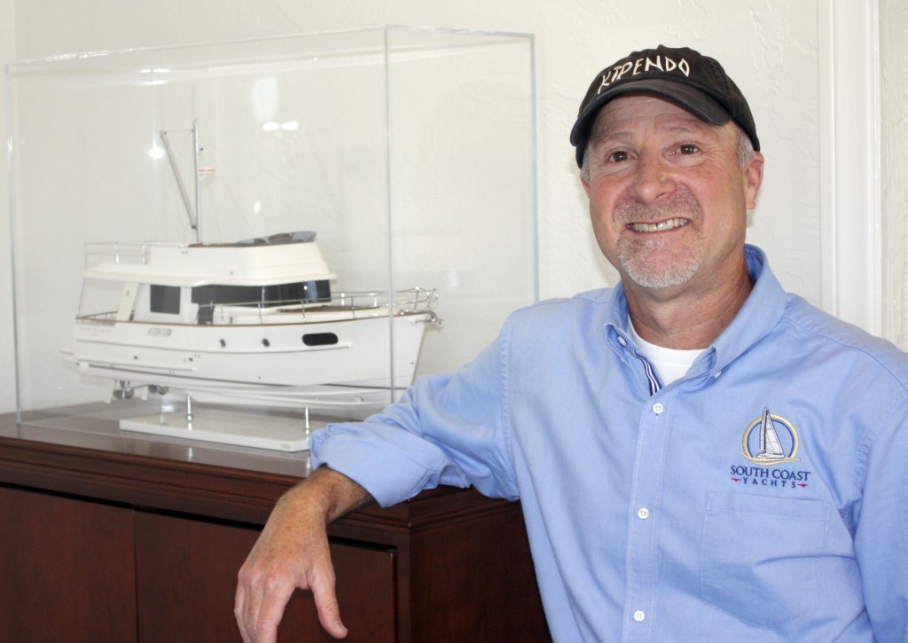 Jody Krimstock with a Beneteau boat model. — Photo by Chris Trela