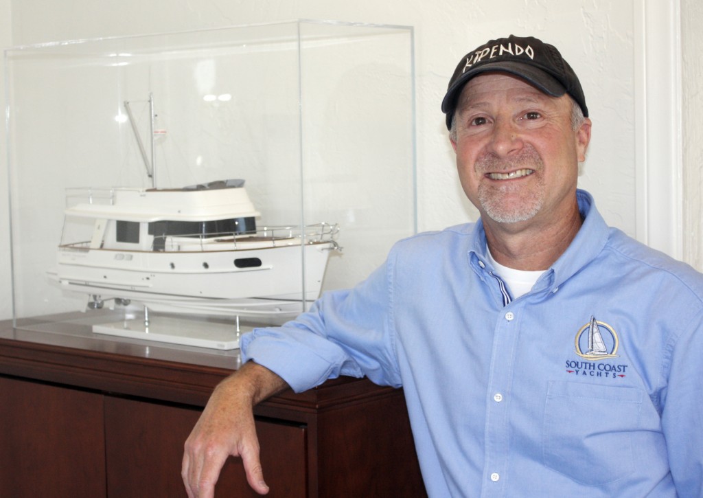 Jody Krimstock with a Beneteau boat model.  — Photo by Chris Trela