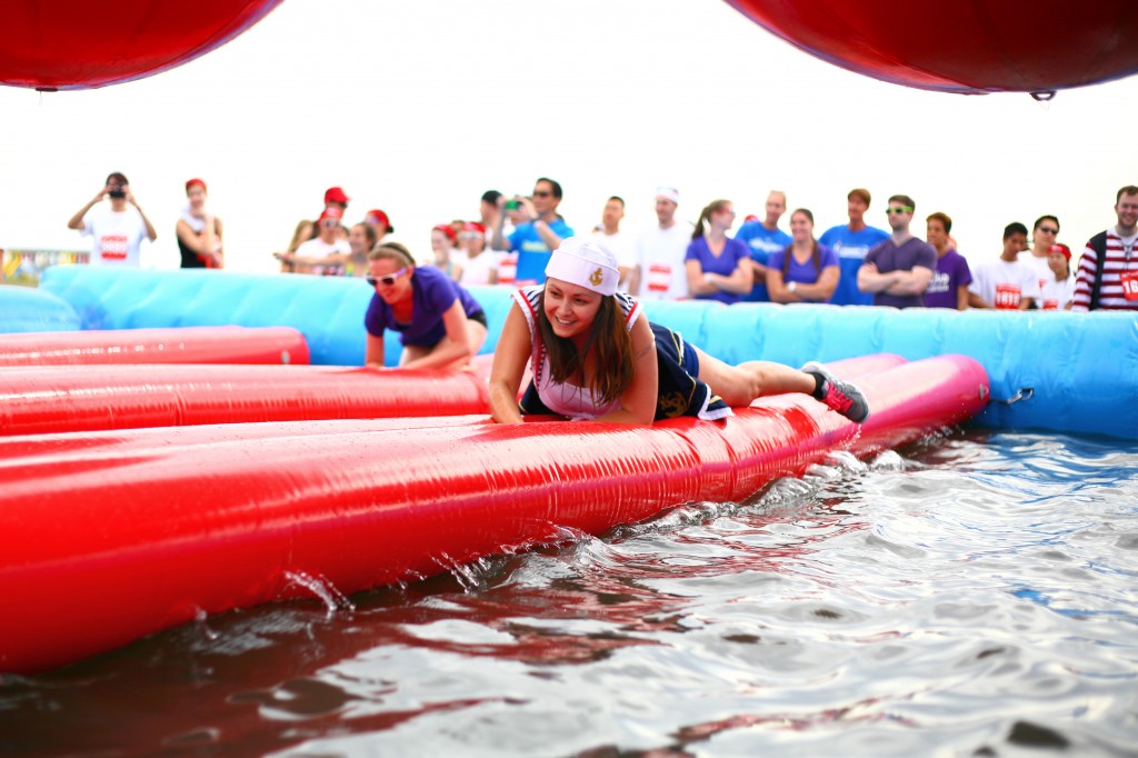 Jackie Dixon crawls across the Duck or Dive obstacle.