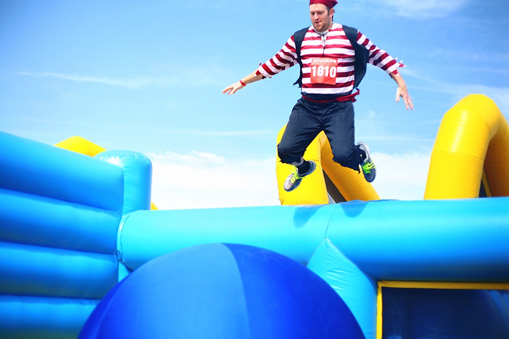 Ted Dixon jumps onto the first oversized bouncy ball in the Bouncy Bridge obstacle.