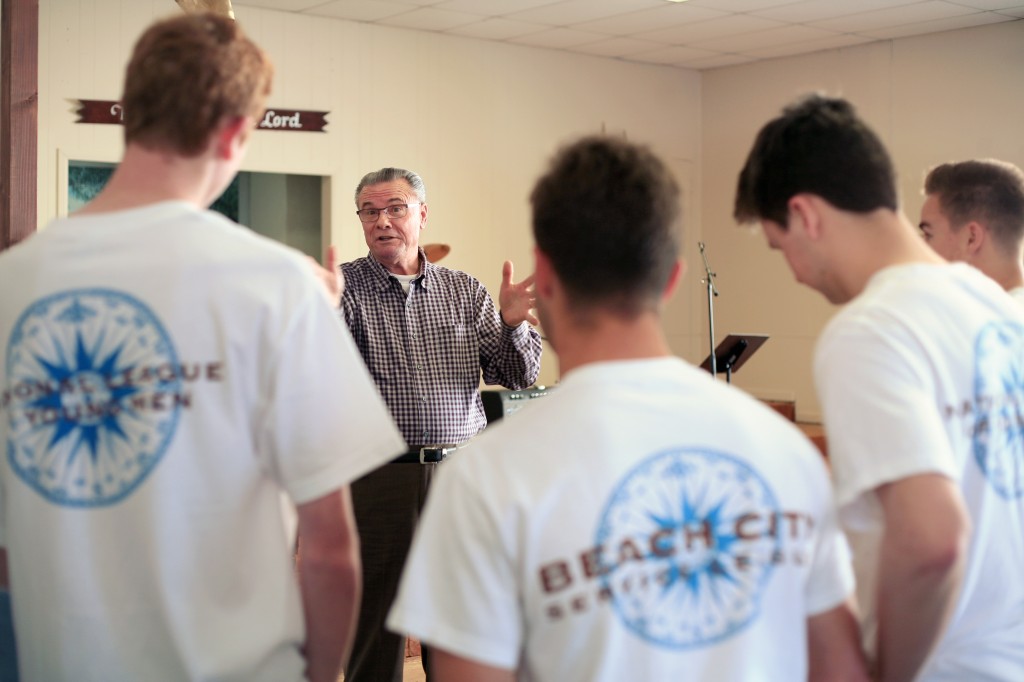 Lighthouse Pastor Phil Eyskens talks to the boys from the National League of Young Men, Newport Mesa chapter, after they helped renovate the building. — All photos by Sara Hall