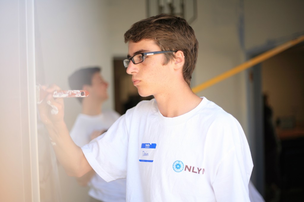 Dain Woods, 15, a sophomore at Corona del Mar High School, paints the foyer at the church as part of the group’s renovation project.