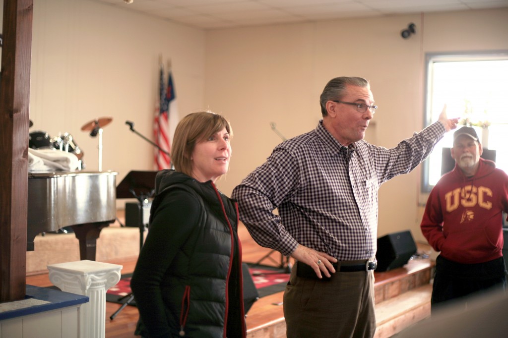 Chris Alessi, NLYM Newport Mesa Chapter’s vice president of philanthropy for the year, shows Lighthouse Pastor Phil Eyskens the progress on the renovation on Saturday.