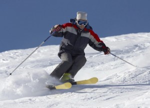 freeride skiing in powder snow against blue sky
