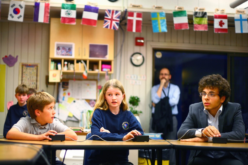 Wanlass (middle) answers a question during the first round of the competition as Ozer (right) listens. Both finished the night on top, with Ozer as regional champ and Wanlass winning the elementary division.