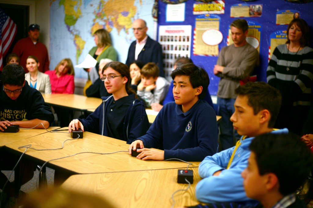 Evan Park (middle), an eighth grader at HDS, listens to a question during the first round of the Bee.