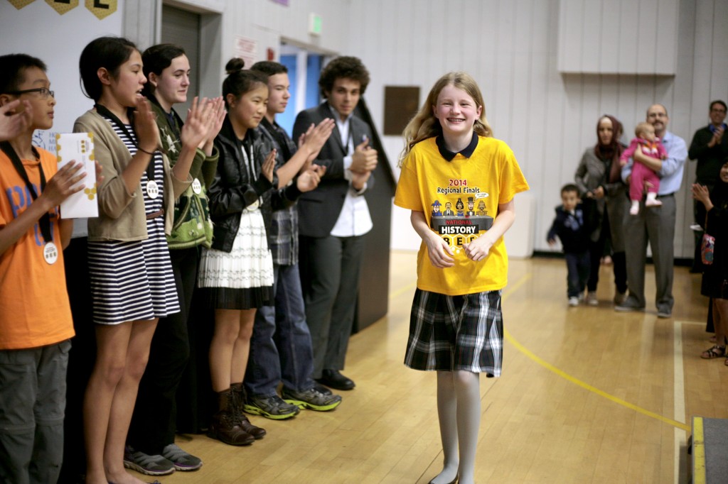 Harbor Day School fifth grader, Jean Wanlass, 11, walks up to the stage as Elementary Division Champion at the Los Angeles regional finals of the National History Bee, held Monday at the Corona del Mar campus. — All photos by Sara Hall