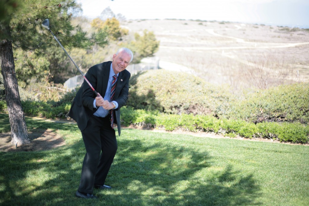 Mayor Rush Hill poses for a photo at the Newport Coast Community Center overlooking the old Coyote Canyon Landfill site in the background, where Hill proposes to build a new, affordable public golf course.  — Photo by Sara Hall