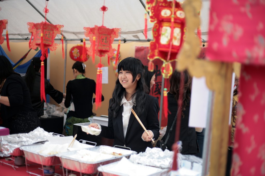 Dana Shan, 15, a sophomore at Sage Hill School helps out at the China booth during the school's 13th Annual Multicultural Fair on Saturday. — All photos by Sara Hall