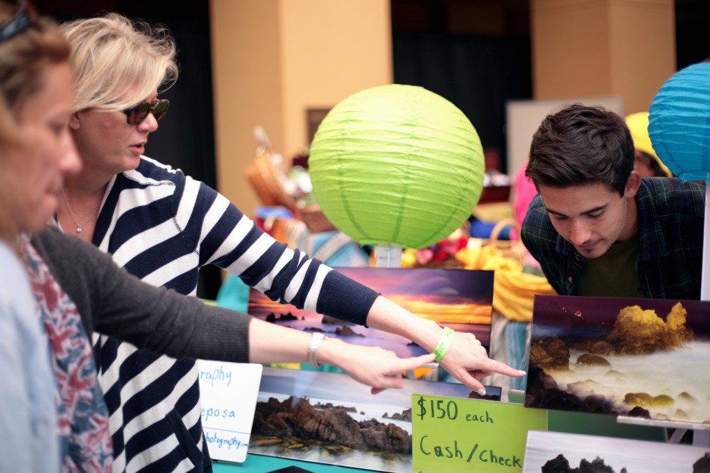 Parker Reposa, 17, a Sage Hill junior describes his long exposure photos to guests in the Artisan's Village.