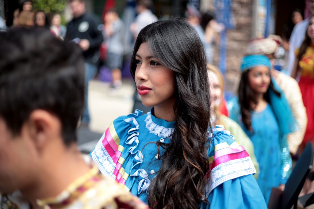 Junior Elizabeth Alvarez, 17, wearing a traditional Mexican outfit, waits to go on stage during the International Fashion Show.