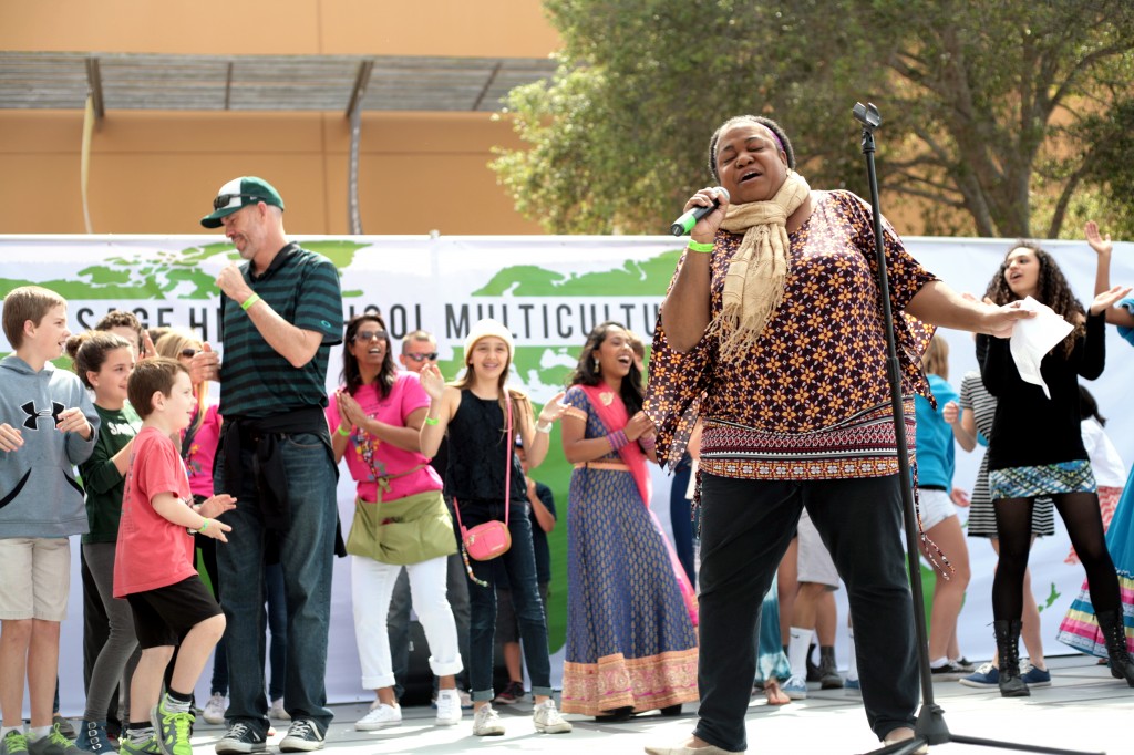 Sage Hill's Associate Director of College Counseling, Nicole Thompson, performs the “Happy” song by Pharrell Williams at the Fair. Members of the audience, including Head of School Gordon McNeill and his kids (left, green shirt and cap), joined her on stage and started dancing.