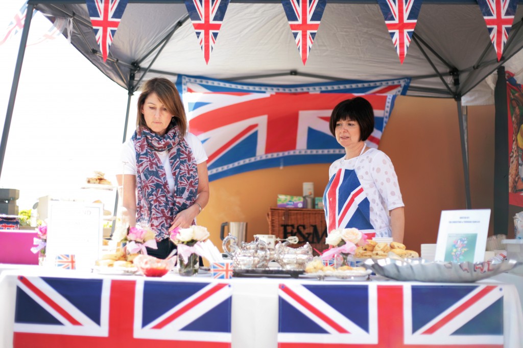 Volunteer moms Debbie Christian of Laguna Beach and Carmen Youhanna of Newport Beach work the British booth during the fair. Christian’s kids, Amelia and Isabella, both 18 and both seniors, and Youhanna’s kids, Helena, 16, and Michael, 18, were helping out in other parts of the event. 