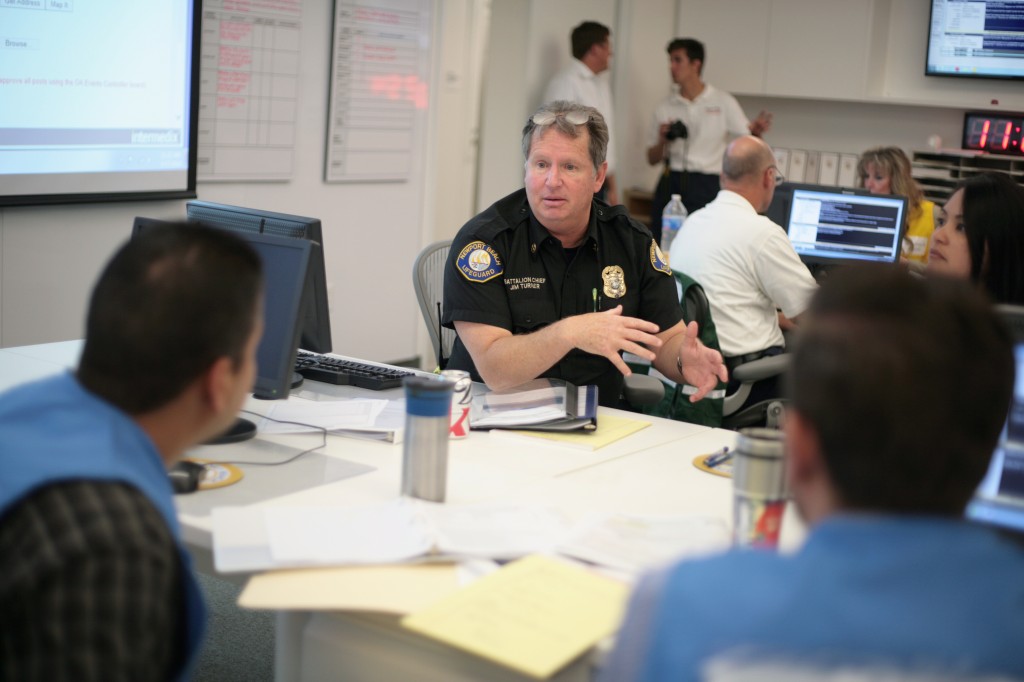 Battalion Chief Jim Turner talks with other emergency staff members during the tsunami drill on Thursday.