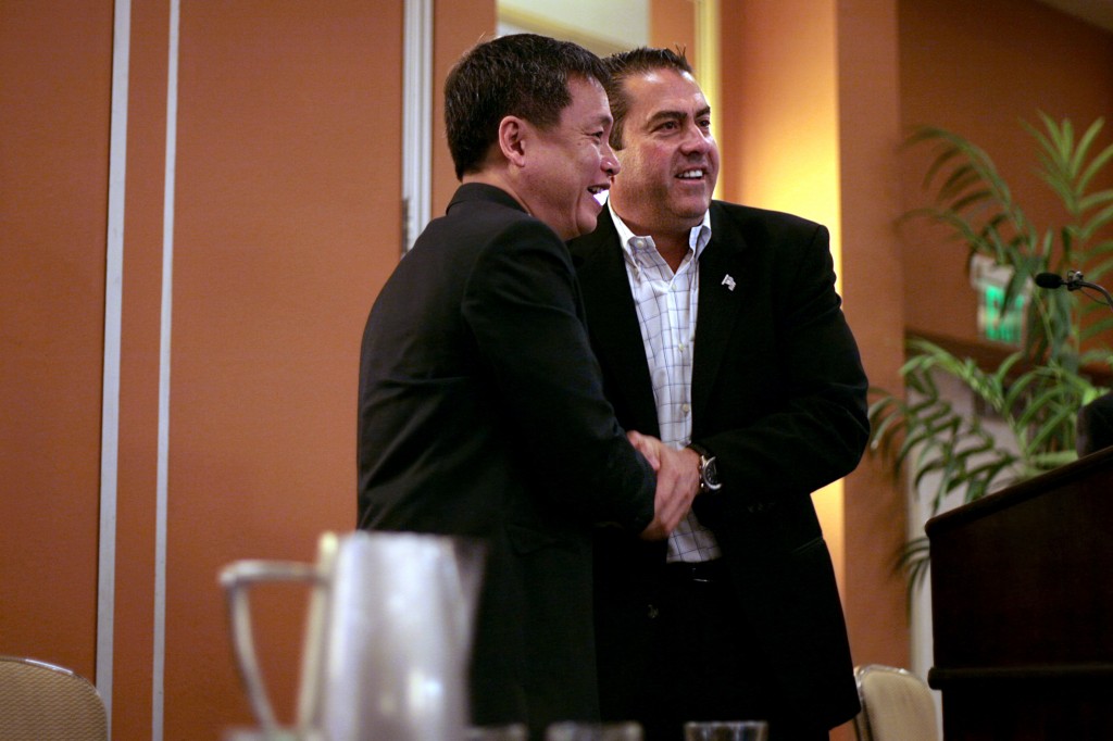 Harry Seah, chief technology officer for Singapore Public Utilities Board, and Shawn DeWane, Orange County Water District board of directors president., shake hands during a discussion at the 2014 WateReuse California Conference held Monday at the Newport Beach Marriott Hotel and Spa. — All photos by Sara Hall