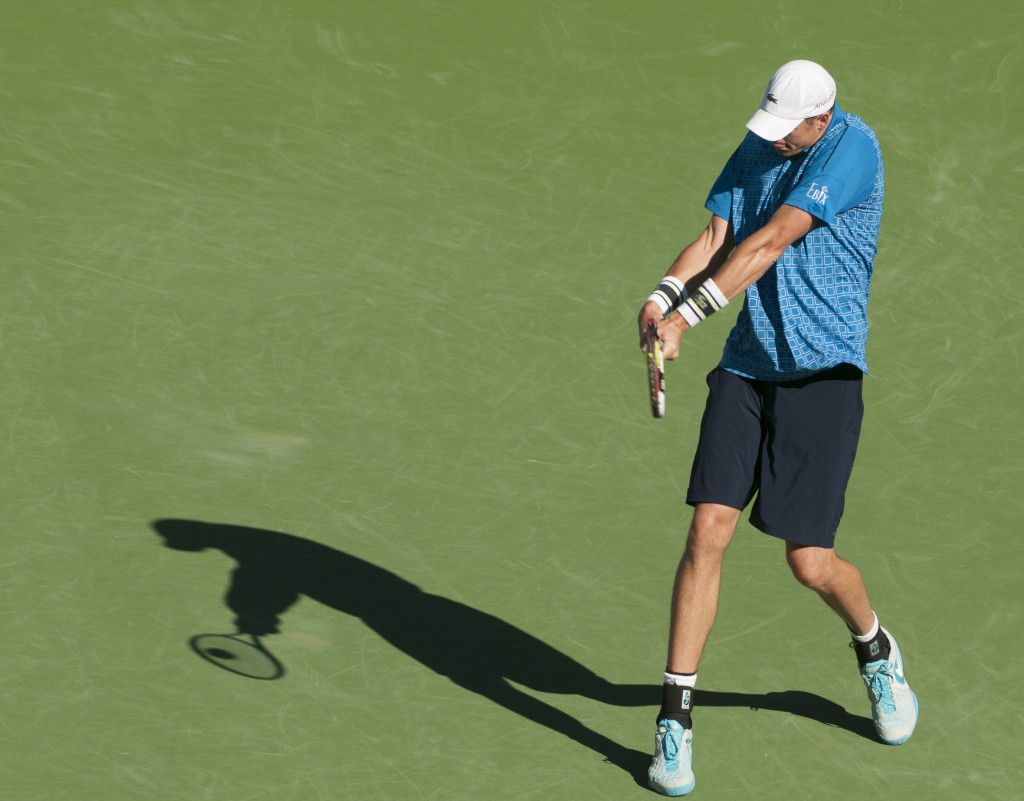 John Isner backhand: flattens tennis ball