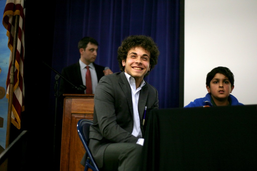 Nuri Ozer, 13, (front, left) an eighth grader from Pacific Technology School in Santa Ana, smiles after answering a question correctly during the regional finals for the National History Bee as Zayan Khanmohammed, another finalist, looks on. Ozer went on to win the event.