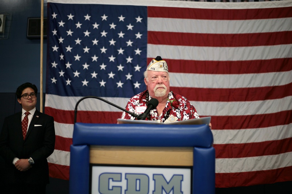 Jack Hammett, founder of the Freedom Committee of Orange County, speaks to the crowd as CdMHS student Arthur Pescan listens.