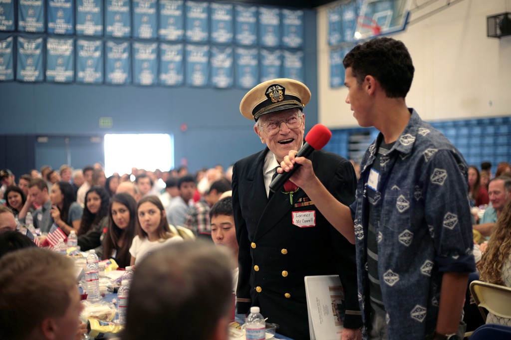 Veteran Lorimer McConnel laughs as his student group introduces him.