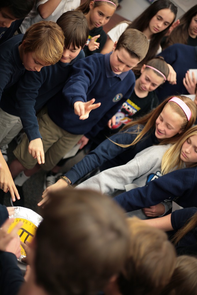 Harbor Day School students touch the pi shrine on March 14, National Pi Day.