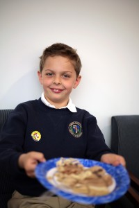 Harbor Day second grader Max Razmjoo, 8, enjoys his pie after reciting 800 digits of pi.