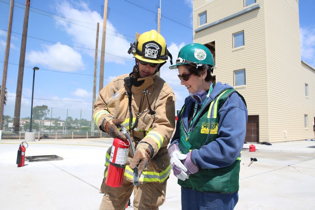 Firefighter Matt Skelly shows a CERT member how to properly use a fire extinguisher. — All photos by Jim Collins