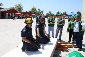 Firefighter Jim Reideler (left) and Captain Charlie Dall explain how to lift heavy objects during outdoor search and rescue.